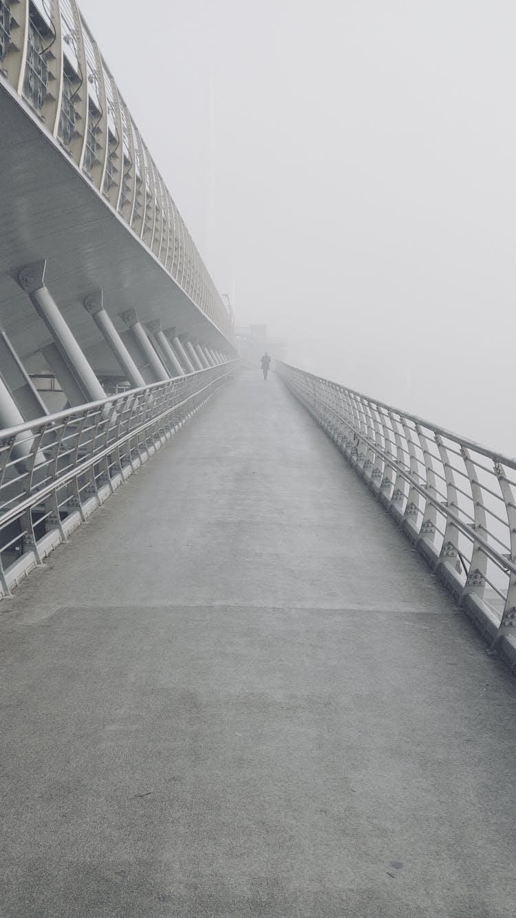 A Long Concrete Footbridge On A Foggy Weather