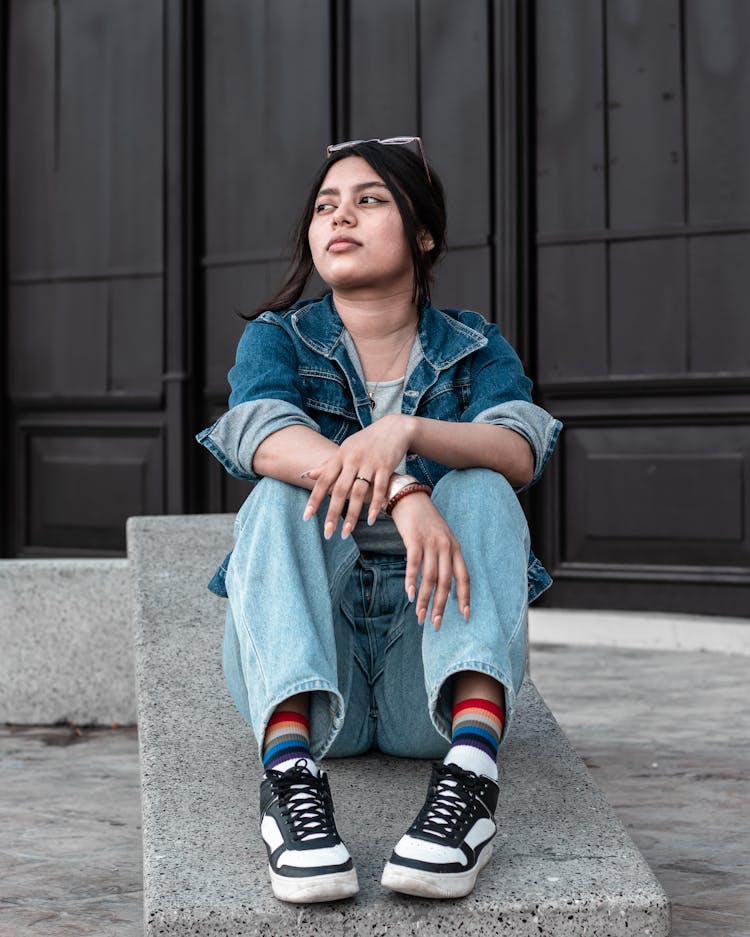 Woman In Denim Wearing Black And White Sneakers