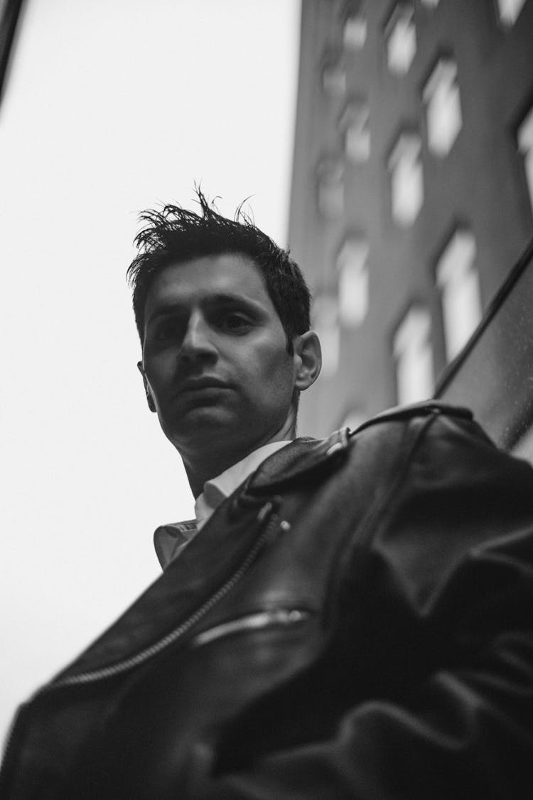 Young Man In Leather Jacket Posing Outdoors