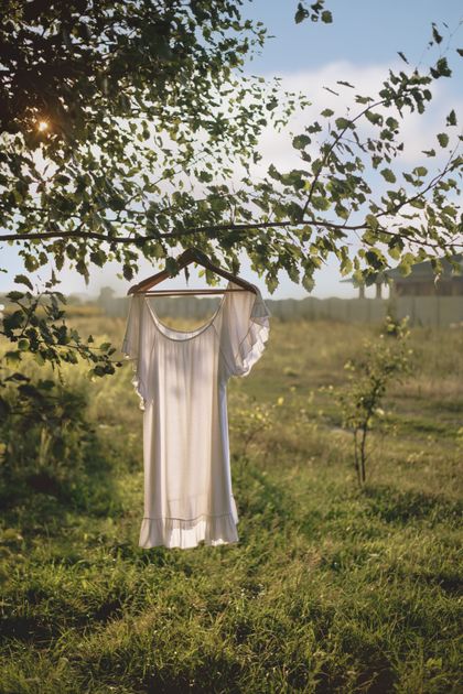 White tiered mini dress on a hanger — photo by Nata Vi on Pexels