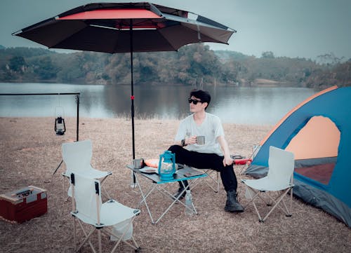 A Man Sitting by a Lake 