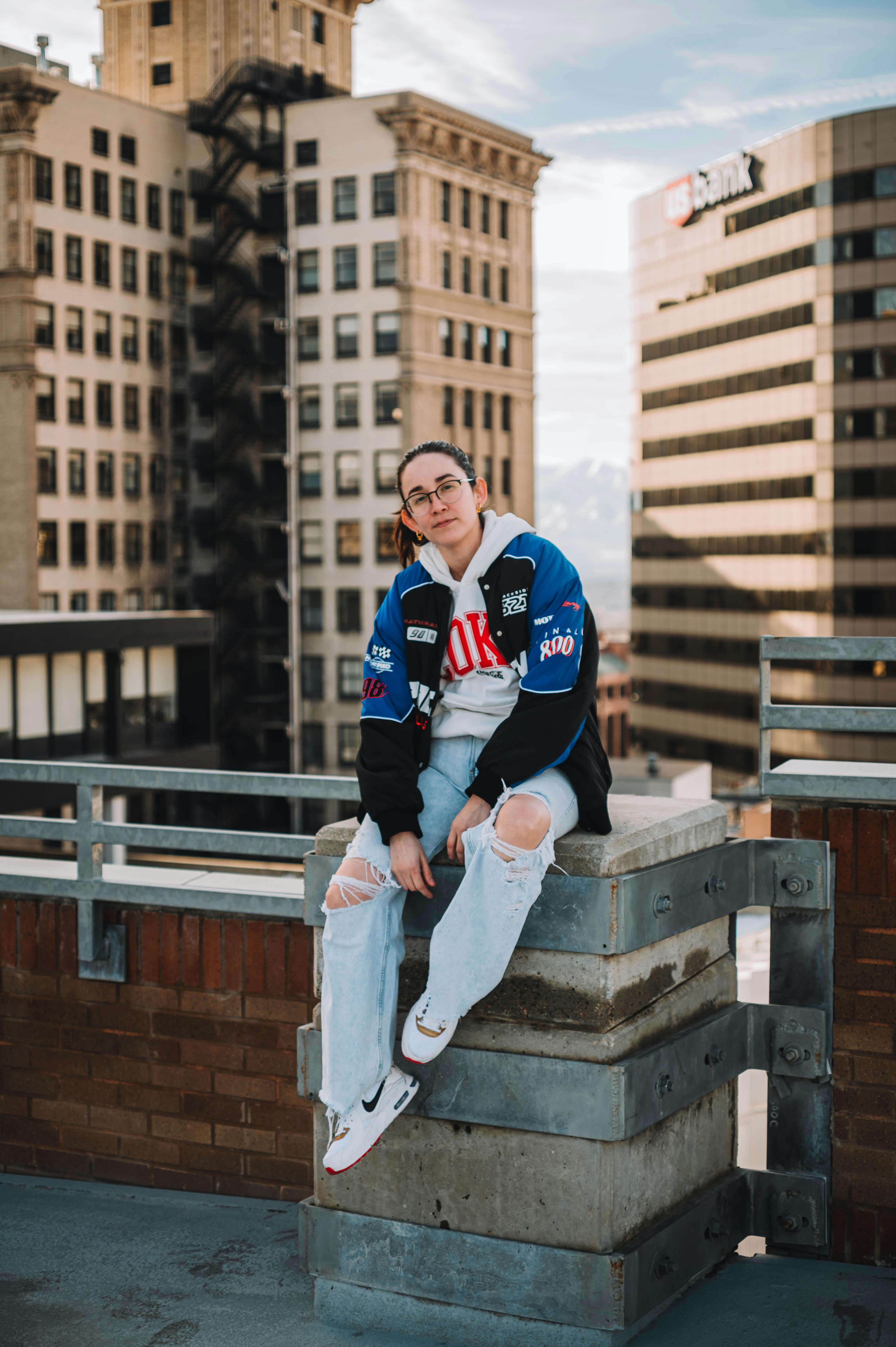 fashionable young woman sitting on a terrace of a skyscraper