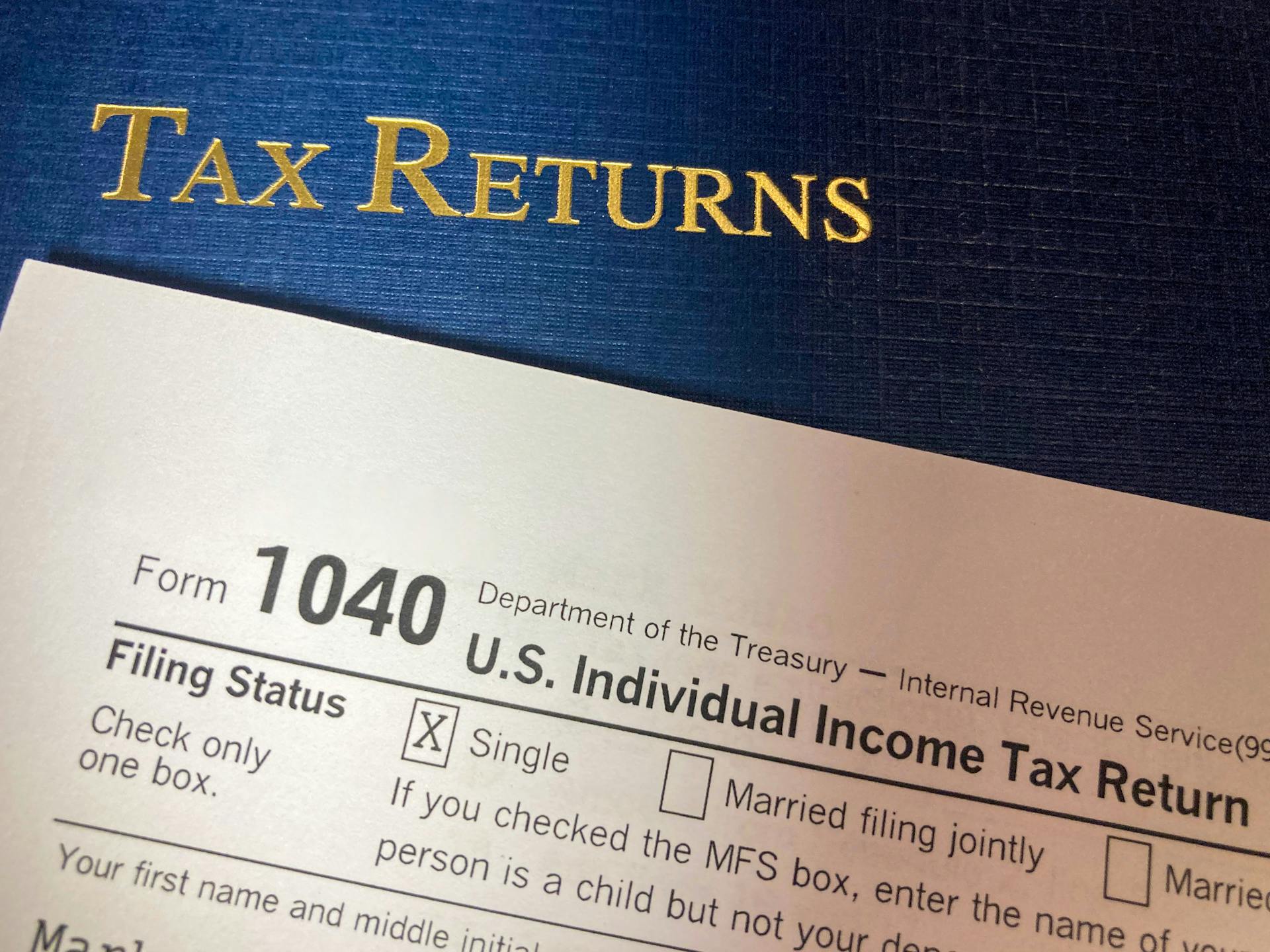 Close-up image of Form 1040 for U.S. tax returns, highlighting filing status options.