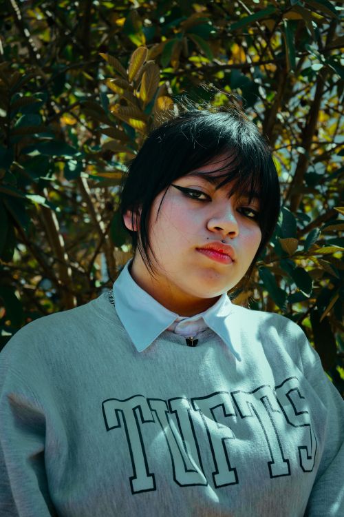 Free Stylish portrait of a young woman outdoors, sporting casual attire and a unique expression. Stock Photo