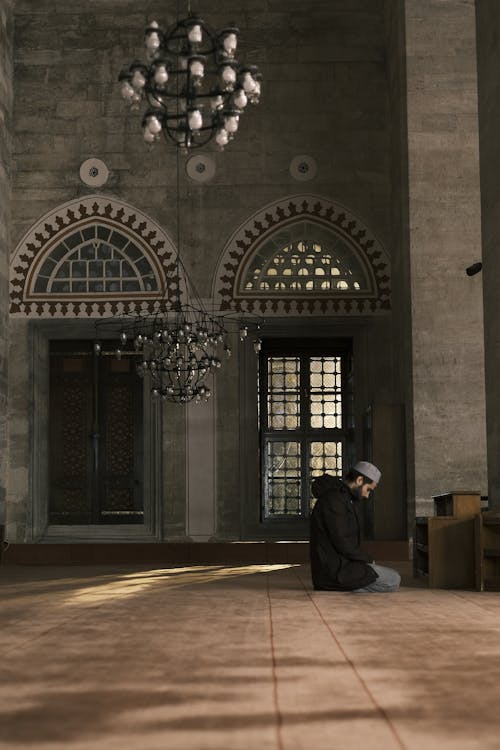 A Man Praying in a Mosque