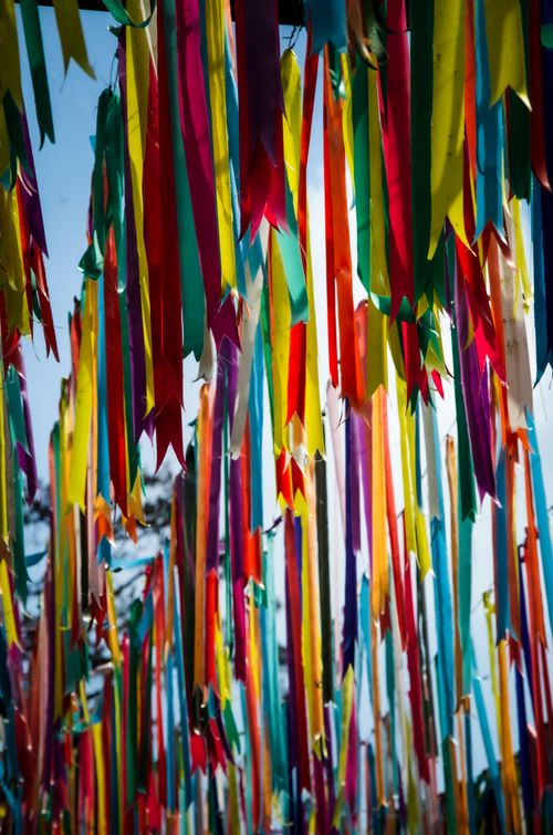 Free Colorful ribbons swaying in the breeze at an outdoor festival, creating a festive atmosphere. Stock Photo