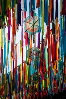 A stunning display of colorful ribbons hanging outdoors, creating a festive and vibrant atmosphere.