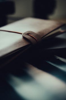 Close-up of a stylish leather notebook secured with a string, offering a touch of elegance.