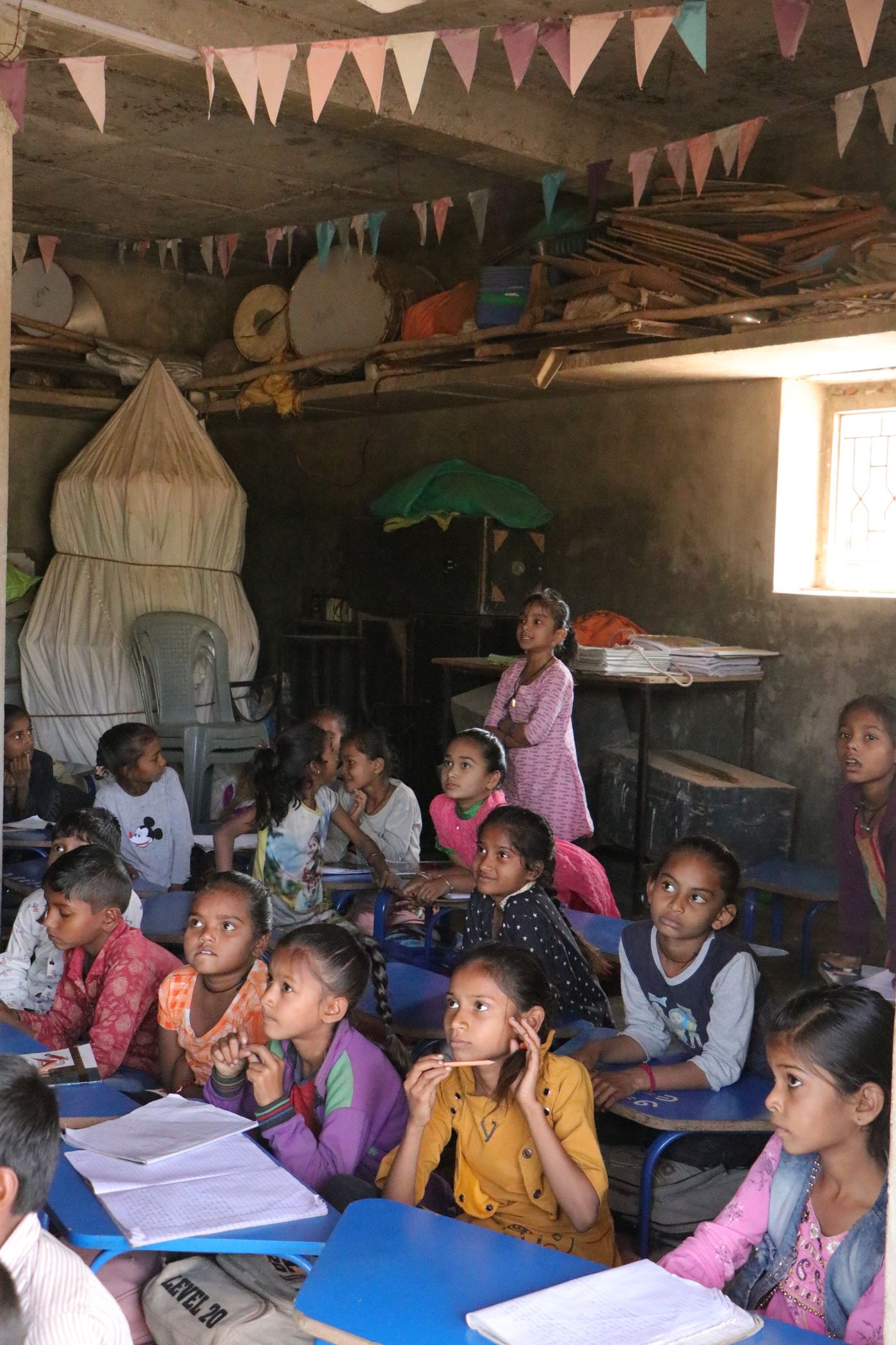 Children studying in a rural classroom in Banaskantha, India, reflecting learning access, encouragement, and school support.