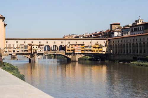 Free Scenic view of the historic Ponte Vecchio spanning the Arno River in Florence, Italy. Stock Photo