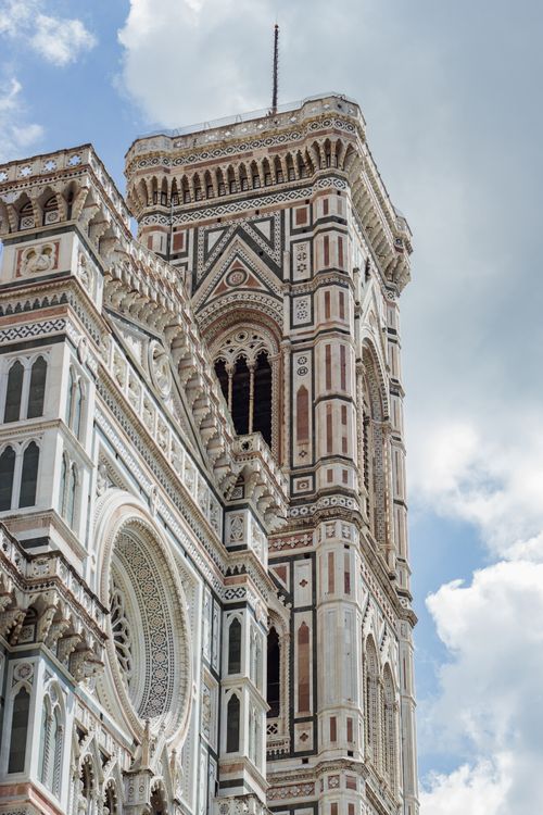 Free Stunning view of the Florence Cathedral's intricate facade and bell tower under a blue sky. Stock Photo
