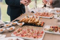 A variety of appetizers displayed elegantly on a buffet table at a social event.