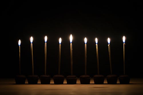 Lighted Candles on Top of Cupcakes