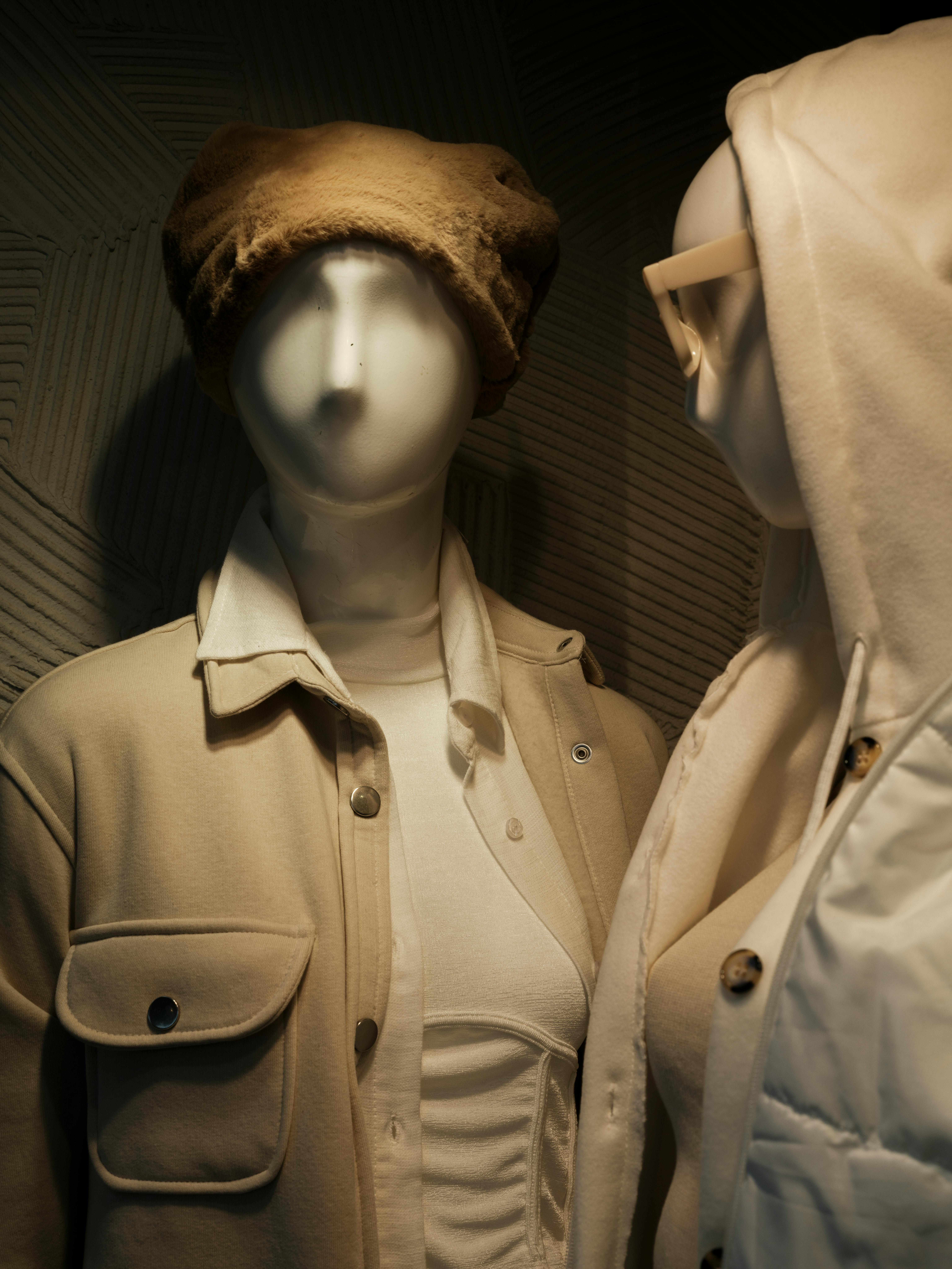 Mannequins Wearing a Beige Jacket and a Hoodie · Free Stock Photo