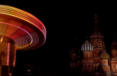 Colorful Carousel near Basilica at Night