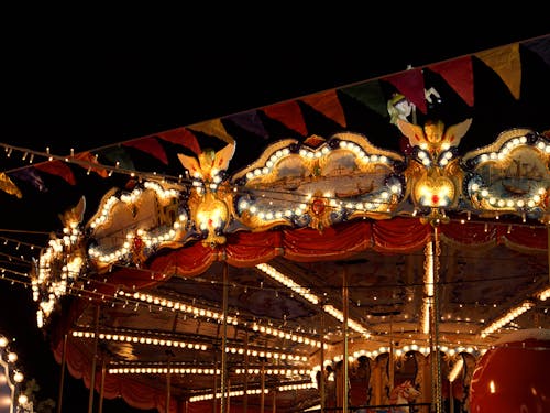 Carousel with Light Bulbs Beside Stringed Banners