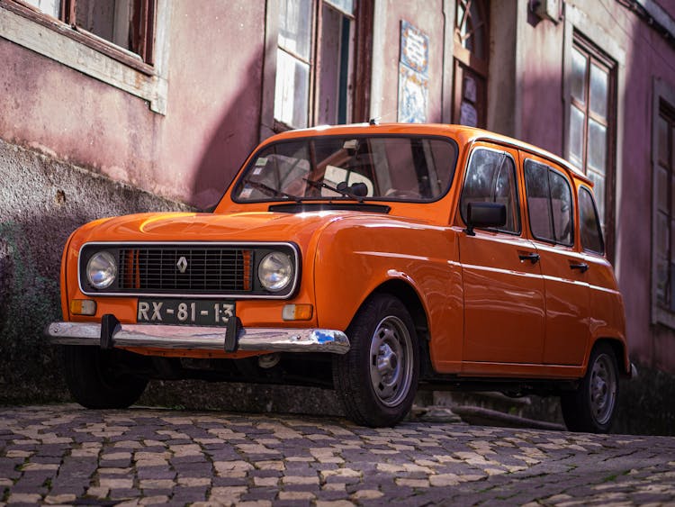 Photo Of Orange Classic Car Parked On Pavement