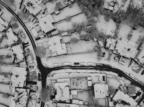 A captivating aerial view of snow-covered houses in Luton, England during winter.