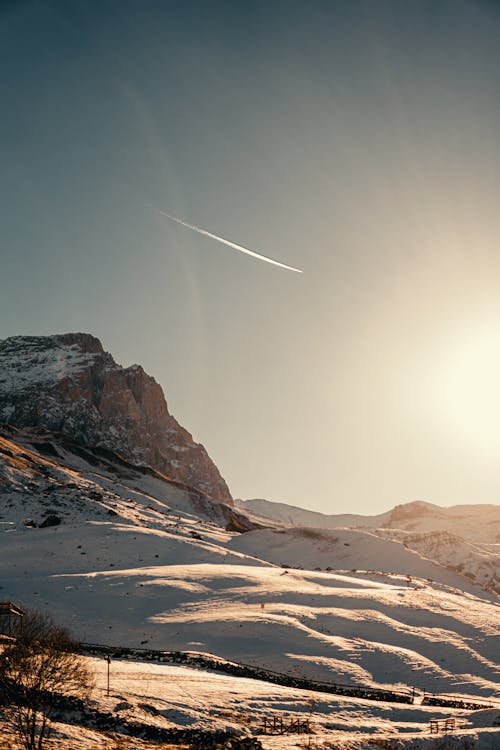 Sunlight on Clear Sky over Mountain in Snow at Sunset