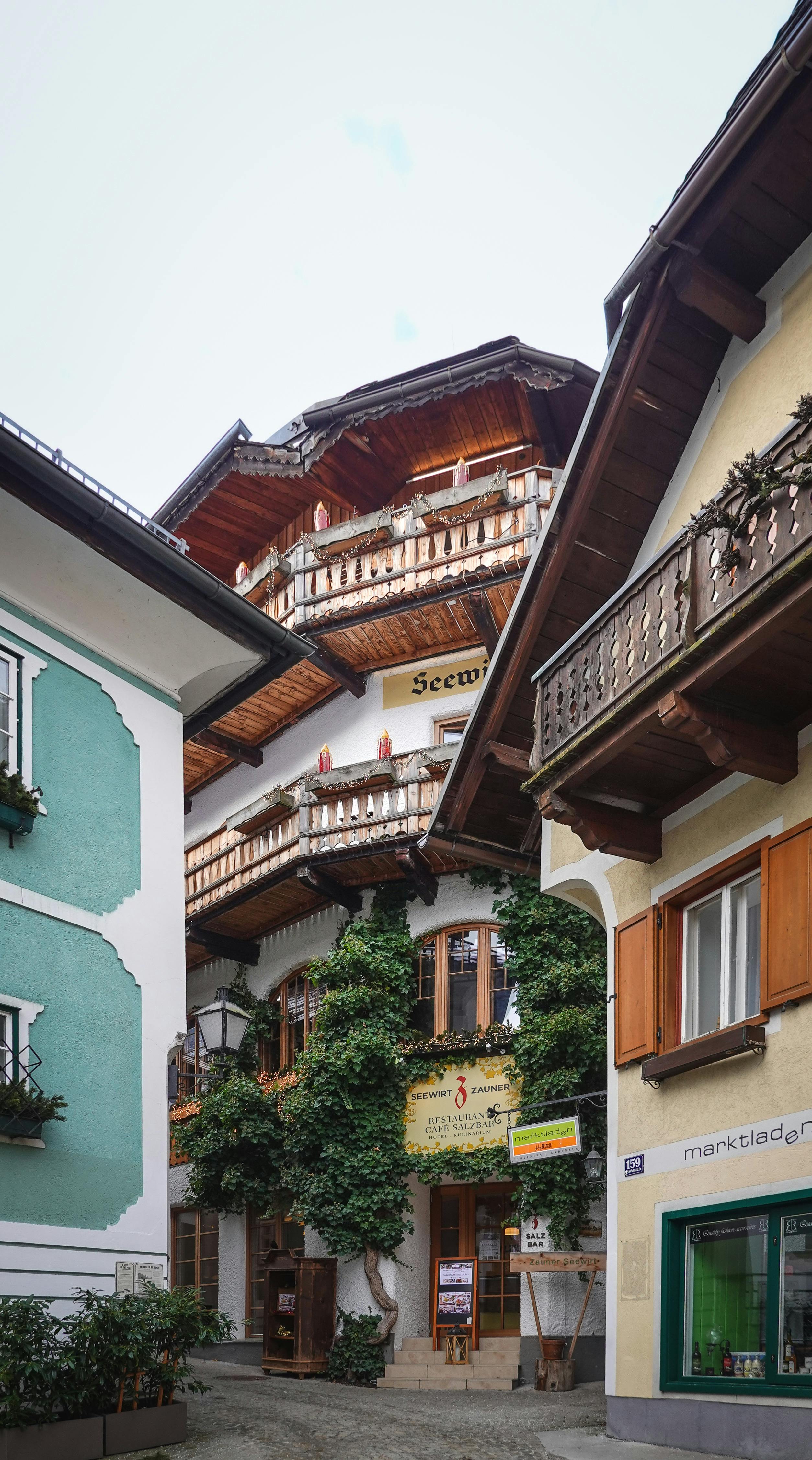 Charming wooden balconies and ivy-clad buildings in Hallstatt, Austria.