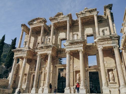 Free The ancient Library of Celsus in Ephesus, Turkey with tourists exploring the historical site. Stock Photo