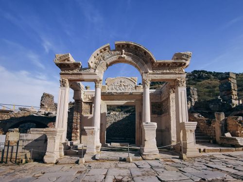 Free Explore the ancient Roman arch and columns in the historic ruins of Ephesus on a clear day. Stock Photo