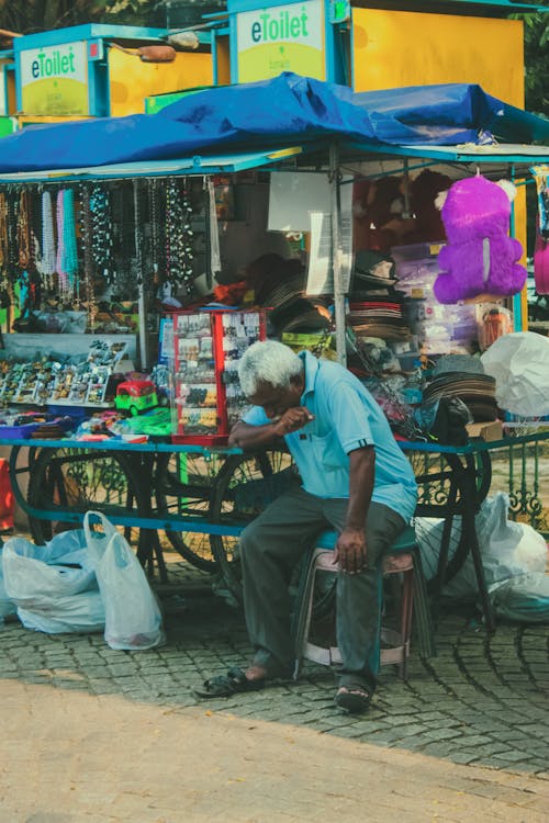 Man Sitting on Street Market
