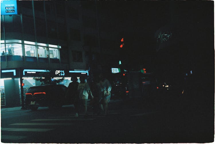 People Walking On The Street During Night Time