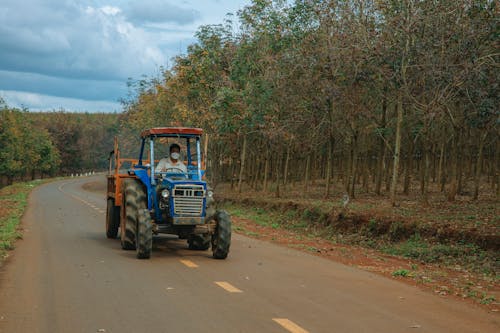 Man Driving Tractor on Road