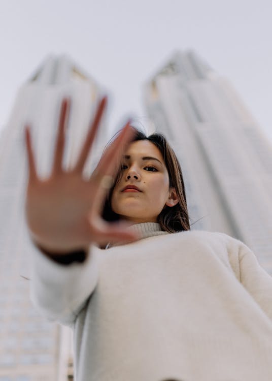 Low Angle View of Woman Reaching her Hand down