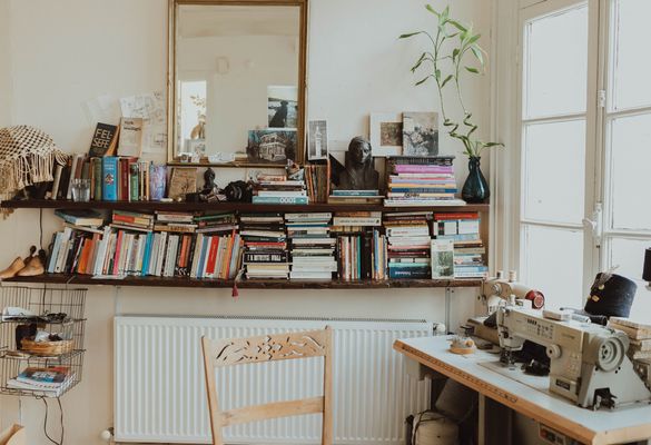 Warm and inviting home office featuring a sewing machine and books