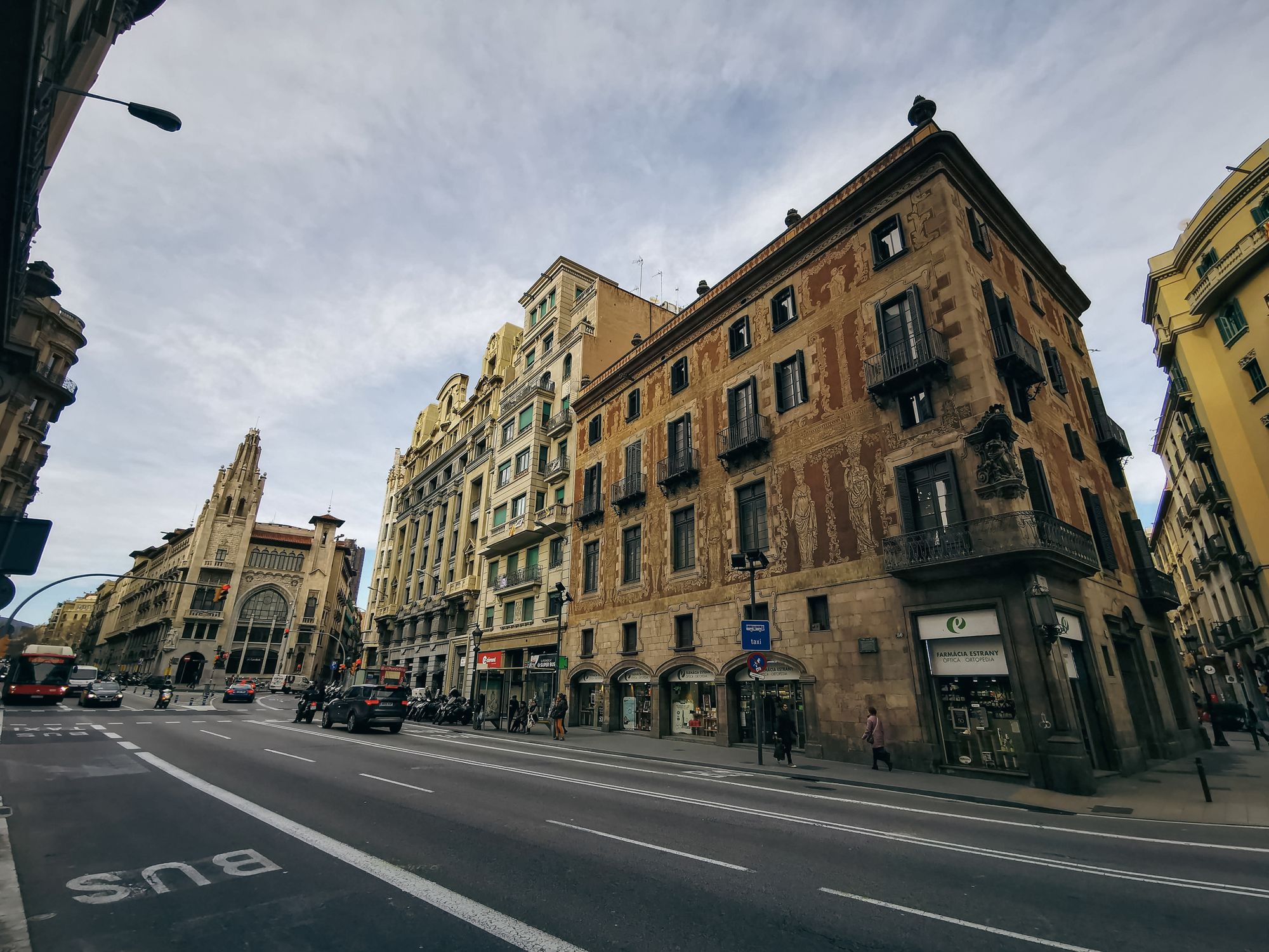 View of a historic street featuring classic European architecture and bustling city life
