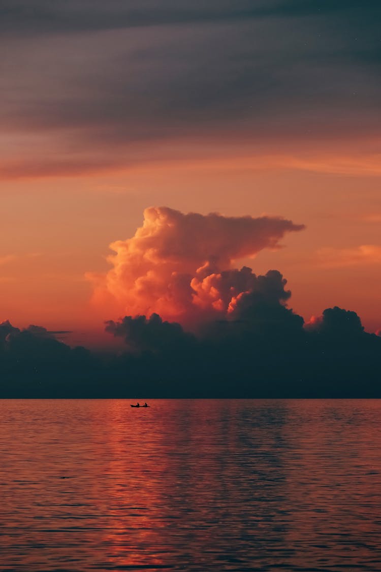 Clouds On Sky Over Water At Sunset