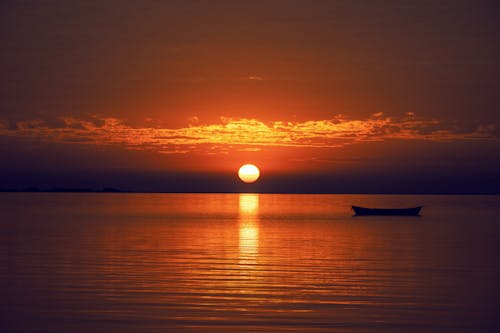 Free Silhouette of a Boat on the Water  Stock Photo