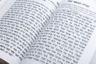 Close-up of an open book displaying Hebrew text, ideal for cultural or religious themes.