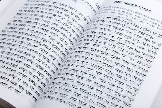 Close-up of an open book displaying Hebrew text, ideal for cultural or religious themes.