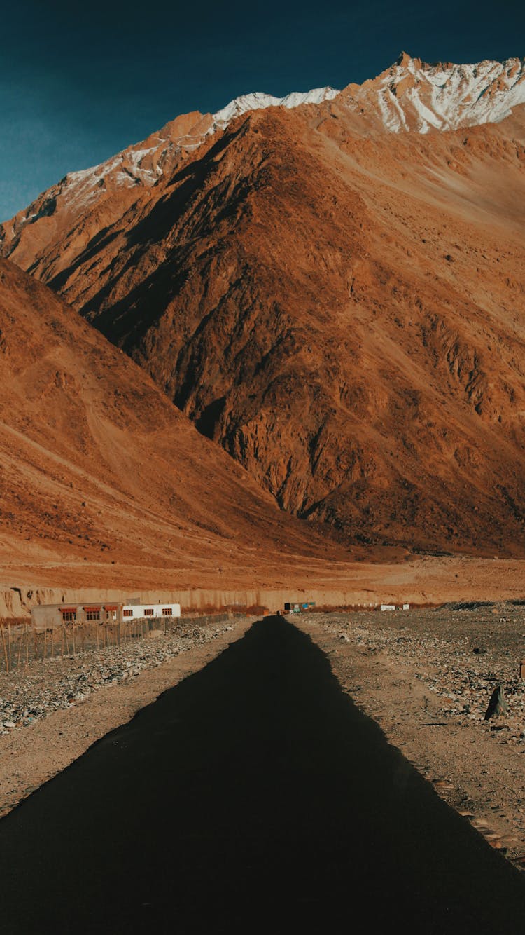 Shadow Cast On Dirt Road In Mountains