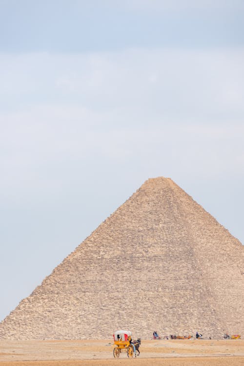 People near Ancient Pyramid in Desert