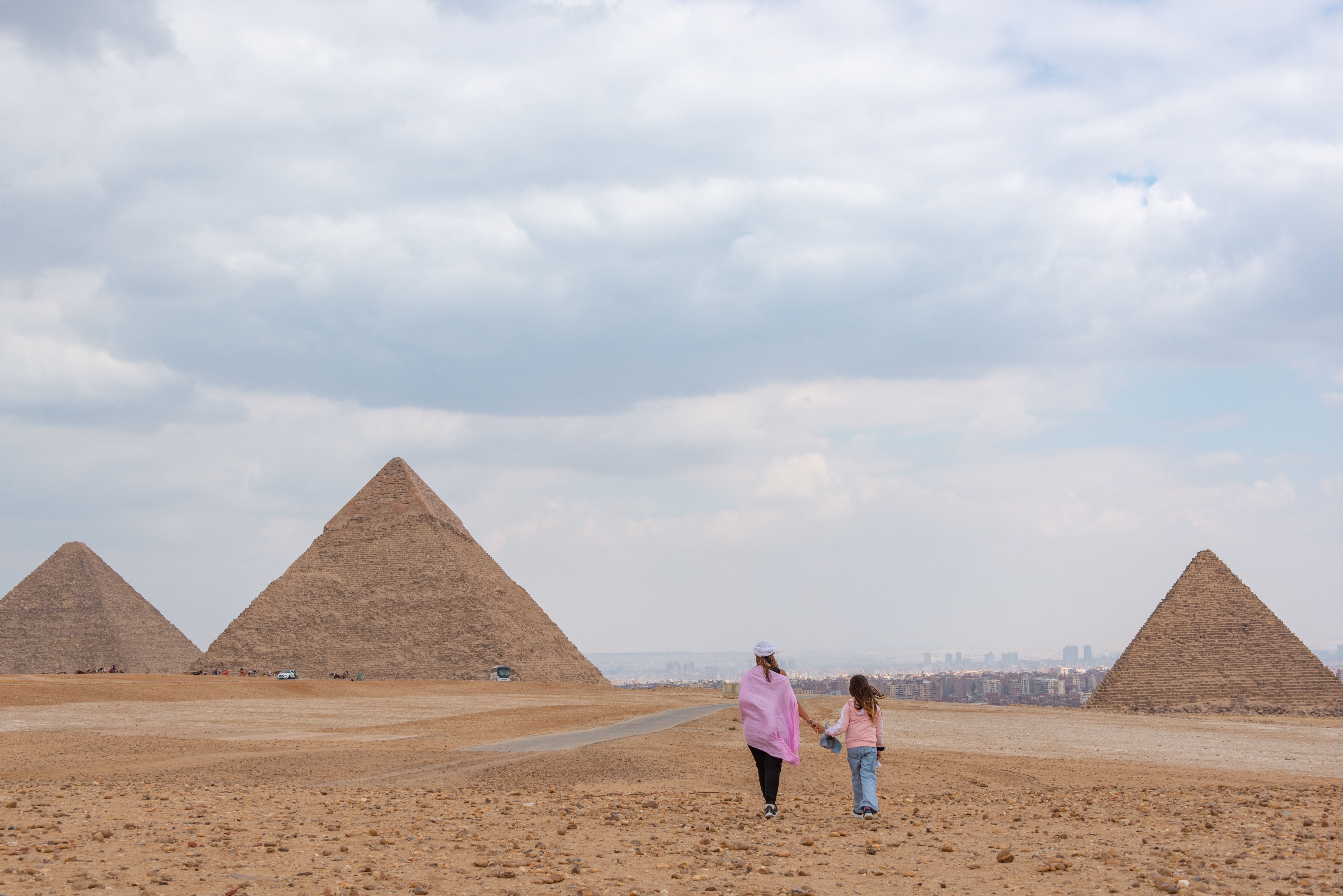 Mother Walking with Daughter towards Pyramids · Free Stock Photo