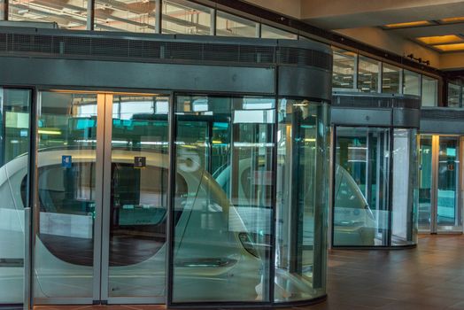 Sleek modern glass enclosure with futuristic design, showcasing innovative architecture.