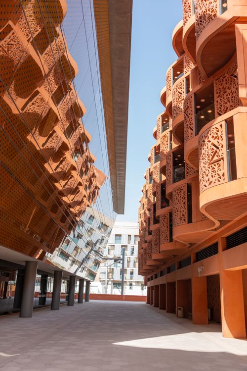Free View of modern architectural buildings with intricate designs under a clear sky. Stock Photo