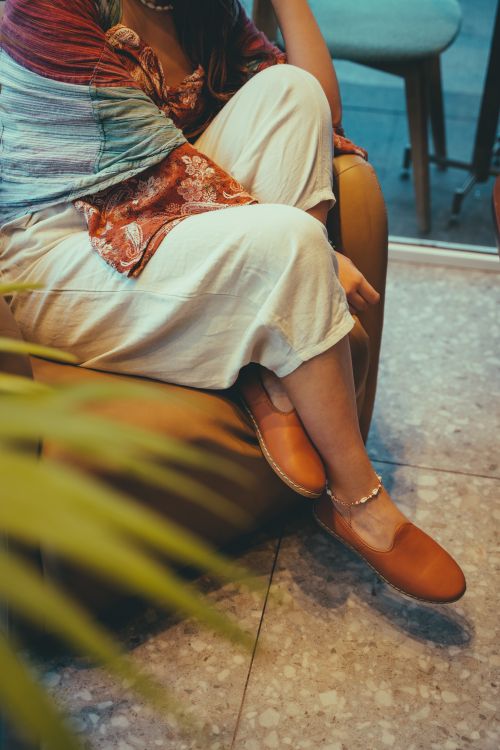 Free Bohemian fashion with colorful textiles and stylish shoes indoors. Stock Photo