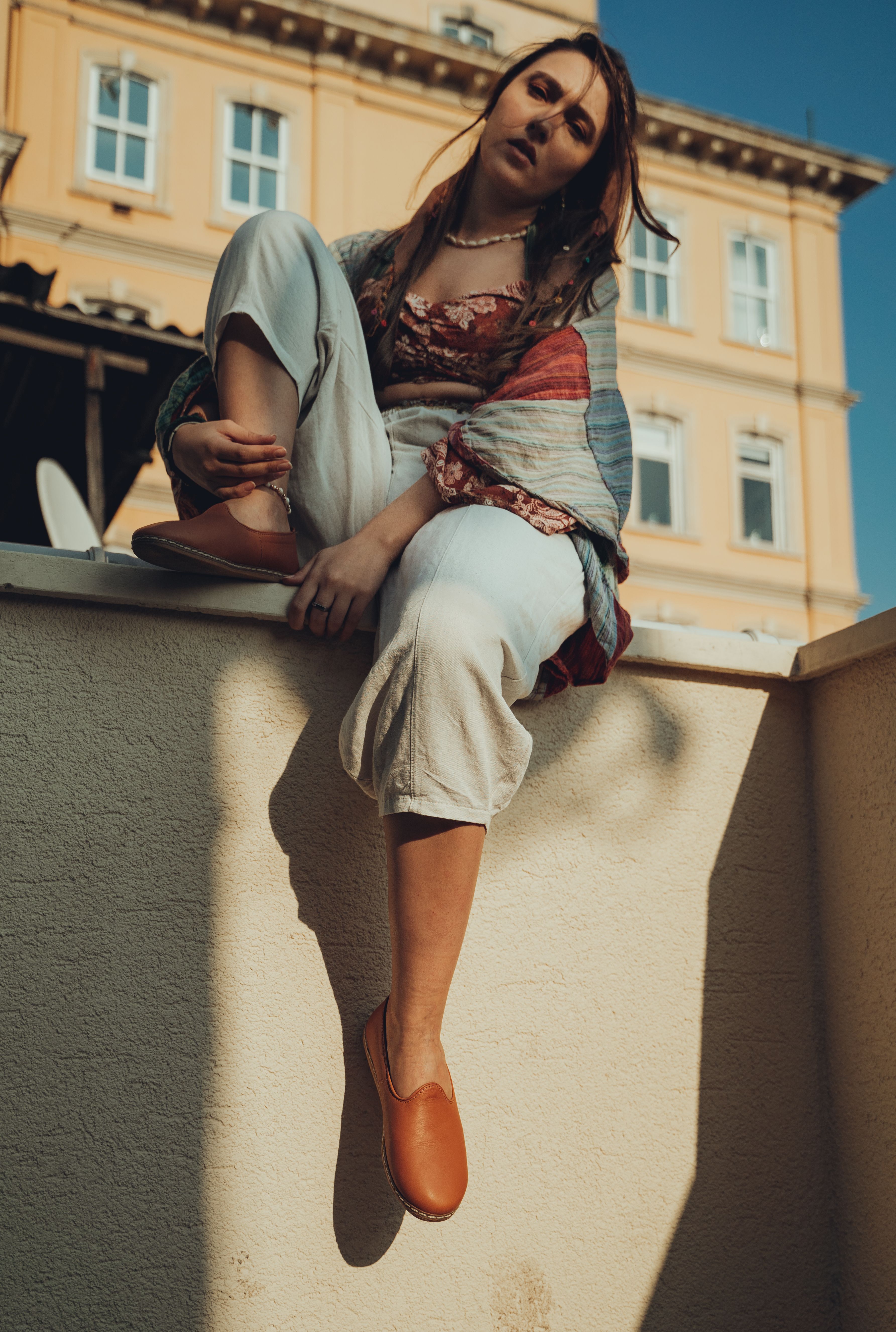 A Woman Sitting on Concrete Wall · Free Stock Photo