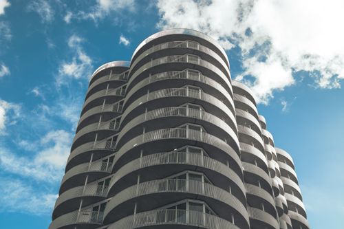 Free Low-angle view of a modern high-rise building with circular balconies in Rotterdam. Stock Photo