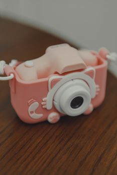Adorable pink toy camera with a whimsical and playful design, perfect for children.