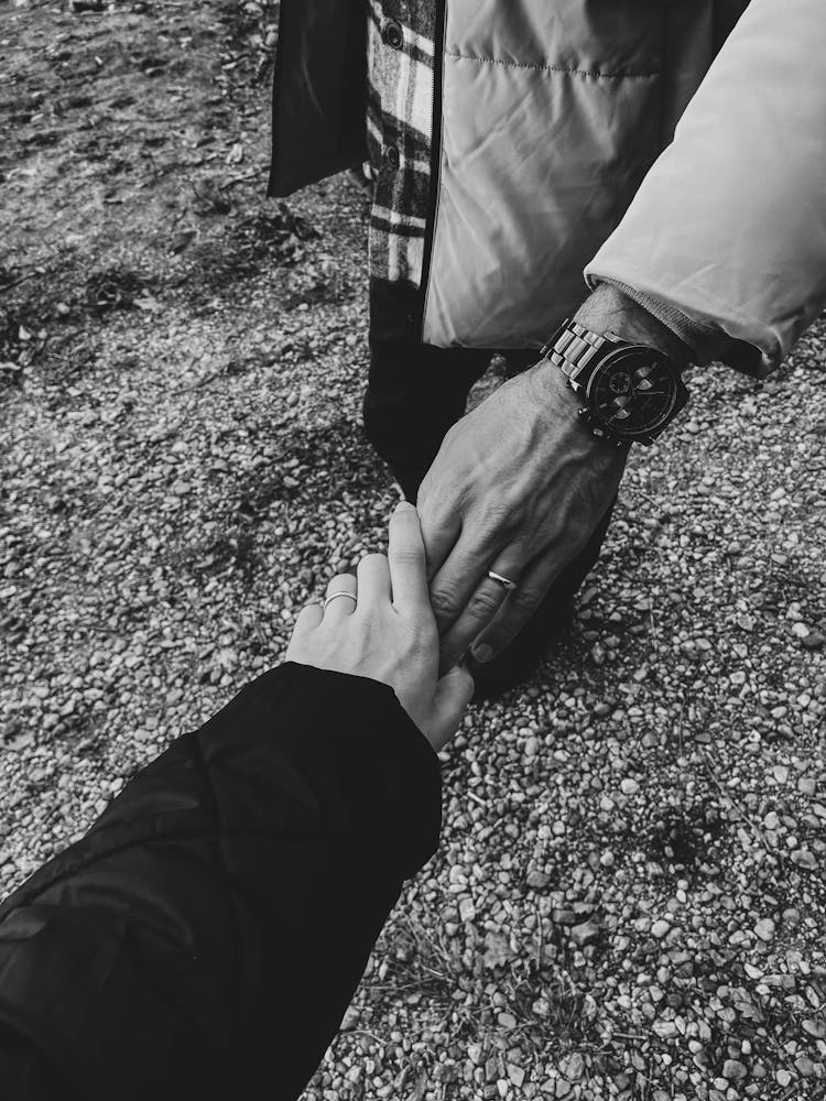 Close-up Of Married Couple Holding Hands