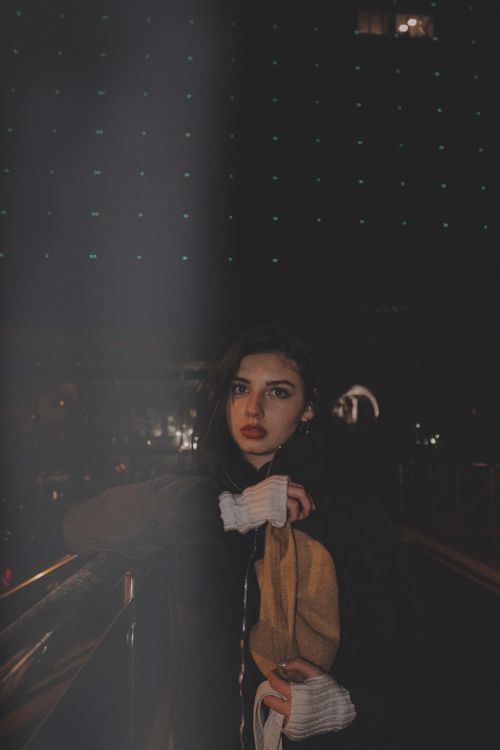 Free Artistic portrait of a woman posing in Ankara at night with moody lighting. Stock Photo