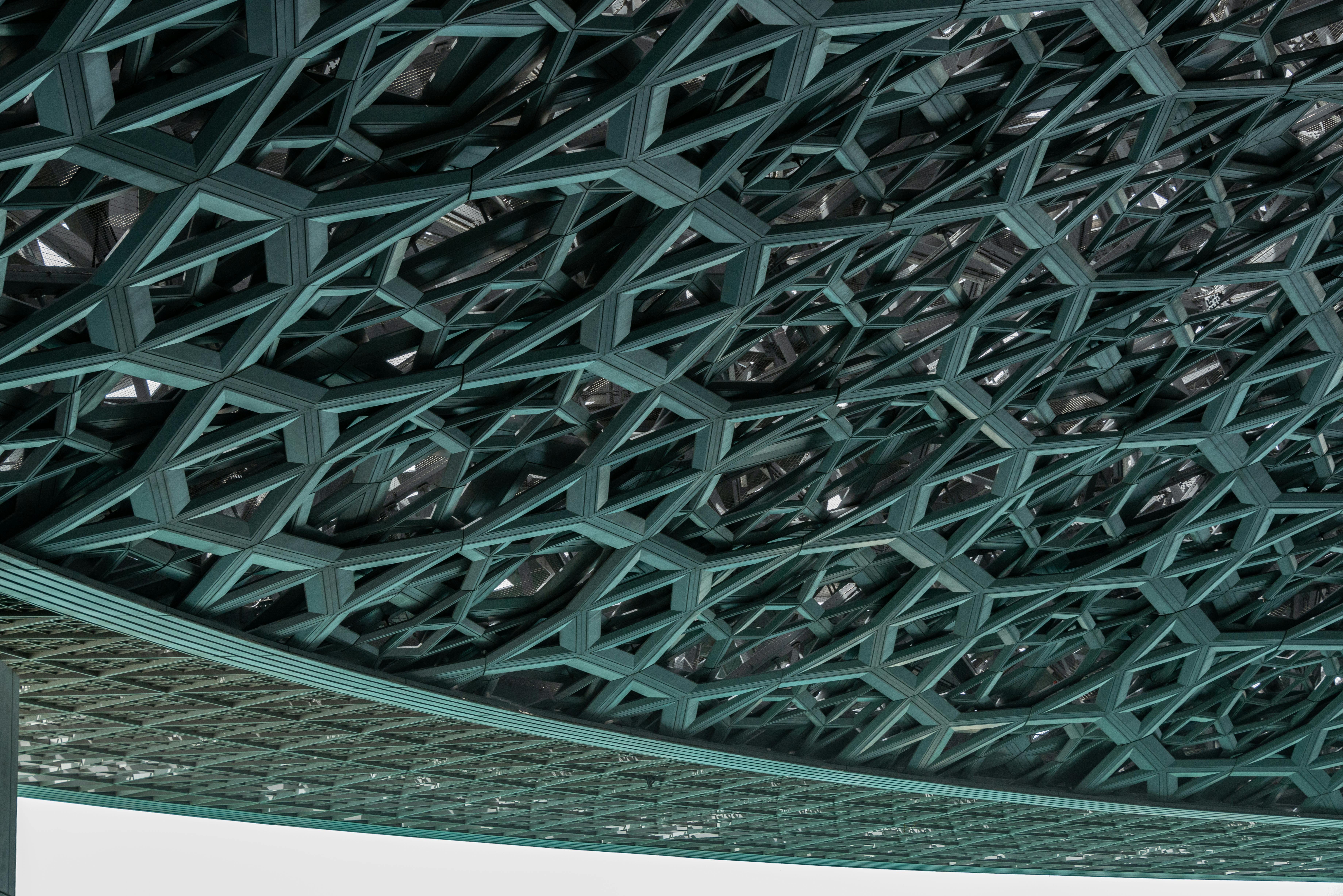 Intricate modern ceiling design at the iconic Louvre Abu Dhabi museum.