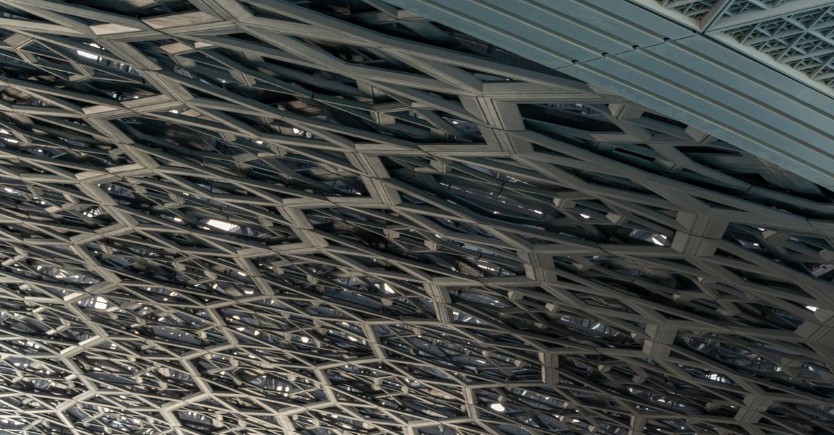 Close-up of the intricate ceiling design at Louvre Abu Dhabi, showcasing modern architecture.