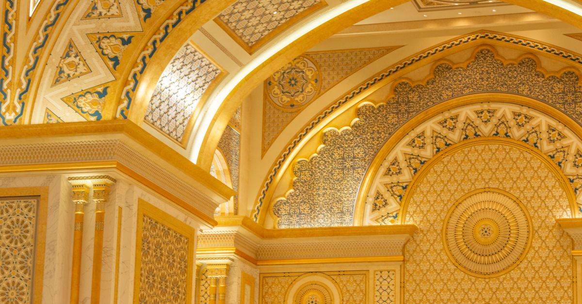 Luxurious palace interior featuring golden ornate decoration and intricate architectural details.